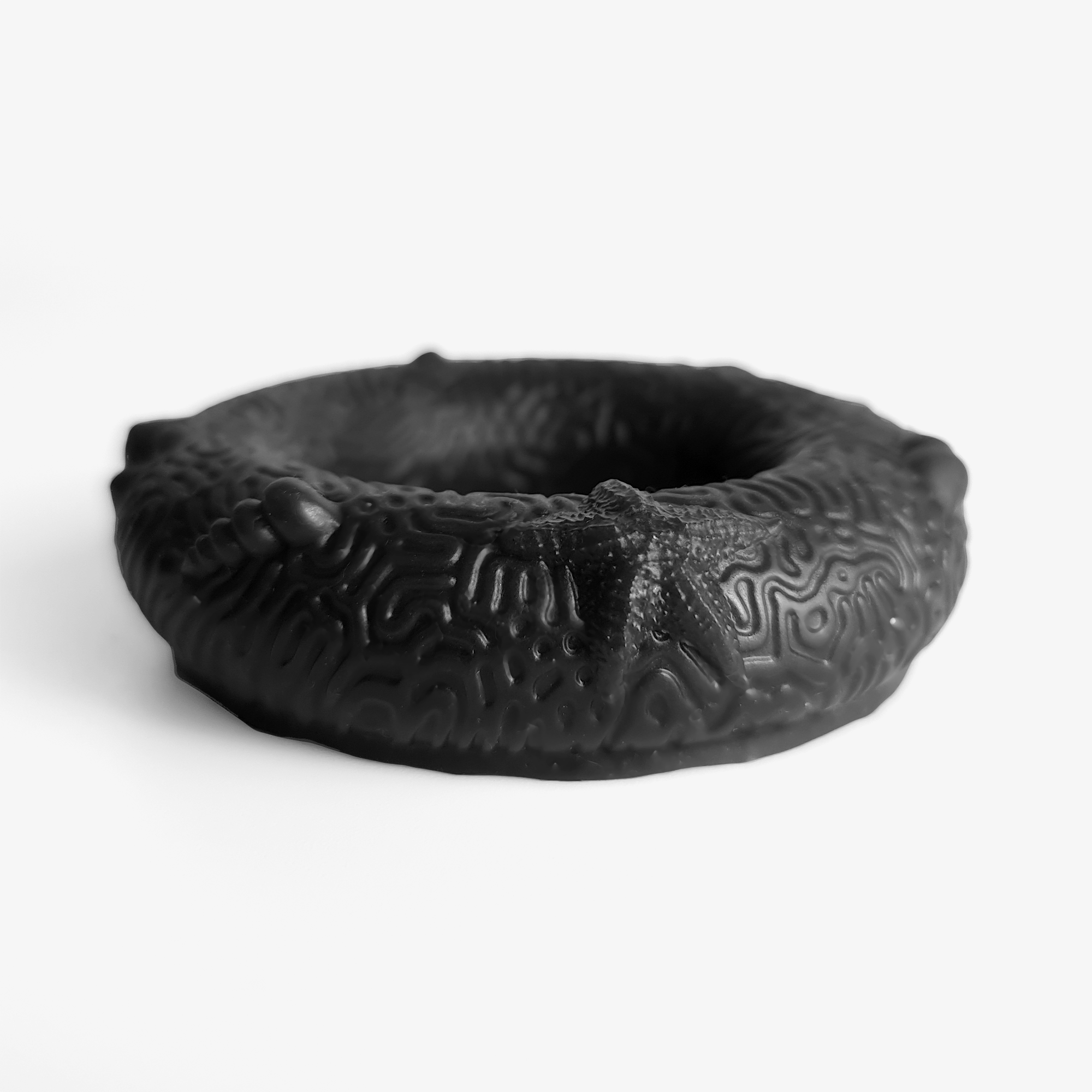 The coral cock ring laying down.